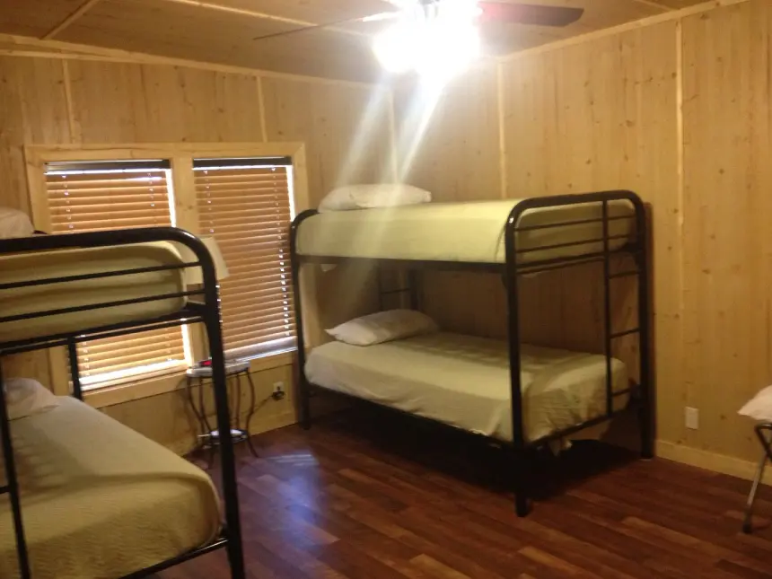 A room with two bunk beds and a window.