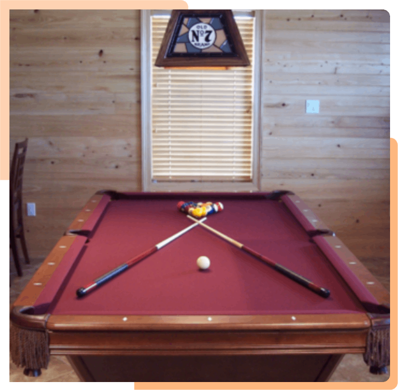 A pool table with two cues and ball on it.